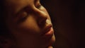 Closeup sensual woman face closed eyes in romantic lights. Beautiful feel love