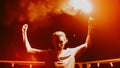 Serious guy protesting against violence. Man standing with signal flare on roof. Royalty Free Stock Photo