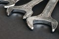 Closeup set of chrome wrenches or spanners isolated on gray table in workshop. Silver wrenches. Mechanic tools. Hardware for Royalty Free Stock Photo