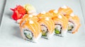 Closeup of a set of delicious fresh sushi rolls with salmon served on a white plate Royalty Free Stock Photo