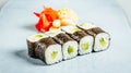 Closeup of a set of delicious fresh sushi rolls served on a white plate Royalty Free Stock Photo