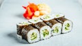 Closeup of a set of delicious fresh sushi rolls served on a white plate Royalty Free Stock Photo