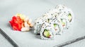 Closeup of a set of delicious fresh  sushi rolls served on a white plate Royalty Free Stock Photo