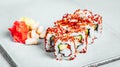 Closeup of a set of delicious fresh  sushi rolls served on a white plate Royalty Free Stock Photo