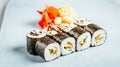 Closeup of a set of delicious fresh sushi rolls served on a white platef Royalty Free Stock Photo
