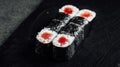 Closeup of a set of fresh delicious Tekka Maki rolls on a black plate Royalty Free Stock Photo