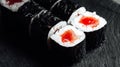 Closeup of a set of fresh delicious Tekka Maki rolls on a black plate Royalty Free Stock Photo