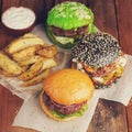 Closeup of set of three mini homemade Burger with marble beef and vegetables on a wooden Board Royalty Free Stock Photo