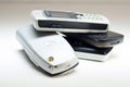 Closeup of several old cell phones on a white surface. Royalty Free Stock Photo