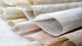 A closeup of several pieces of linen fabric with different colors and textures.