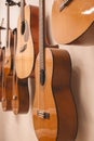 Closeup of several Spanish guitars hanging on the wall, after a music class Royalty Free Stock Photo