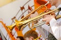 A closeup of several trumpeters playing in a brass band