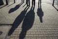 Closeup of shadows of people on a cobble street in Warsaw, Poland