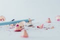 Closeup of a sharpened blue pencil with pencil shavings on white surface