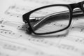 Closeup of Sheet Music and eyeglasses. Musical Notes with Selective Focus Royalty Free Stock Photo