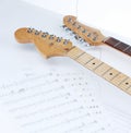 Closeup .sheet music and guitar on a white background. Royalty Free Stock Photo