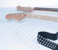 Closeup .sheet music and guitar on a white background. Royalty Free Stock Photo