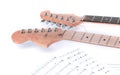 Closeup .sheet music and guitar on a white background. Royalty Free Stock Photo