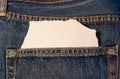 Closeup of a sheet of ripped blank paper with space for text in a back pocket of jeans