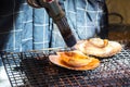 Closeup shell on grill. Action of burning shell by Butane torch. Royalty Free Stock Photo