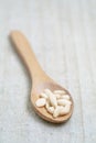 Shelled pine nuts in spoon on the wooden background with copy space Royalty Free Stock Photo