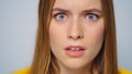 Closeup shocked attractive woman looking at camera on grey background.