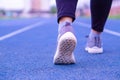 Closeup shoe. Female legs jogging and walking on the running track. Sport and exercise concept