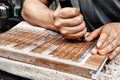 Closeup shot of adult hands doing the traditional Chinese woodblock printing