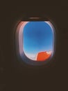 A closeup shot of airplane wings shown through the window with beautiful clouds in background Royalty Free Stock Photo