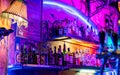 Closeup shot of alcohol drinks in bottles in a colorful bar with neon lights