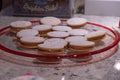 Closeup shot of alfajores cookies filled with dulce de leche on a glass plate