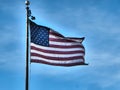 Closeup shot of American flag on the flagpole waving in the wind under a blue sky in Arizona, USA Royalty Free Stock Photo