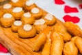 Closeup shot of appetizing desserts on a wooden board with a blurred background