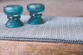 Closeup shot of aqua candle holders on a black and white patterned table cloth in the kitchen Royalty Free Stock Photo