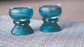 Closeup shot of aqua candle holders on a black and white patterned table cloth in the kitchen Royalty Free Stock Photo