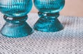 Closeup shot of aqua candle holders on a black and white patterned table cloth in the kitchen Royalty Free Stock Photo