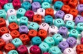 Closeup shot of an array of colorful cubic beads with letters