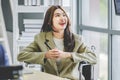 Closeup shot of Asian pretty happy cheerful disabled handicapped female businesswoman intern trainee in casual suit sitting