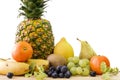 Closeup shot of assorted different fruits on a wooden table with a white background behind Royalty Free Stock Photo