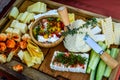 Closeup shot of an assortment of different cheese types on a wooden surface Royalty Free Stock Photo