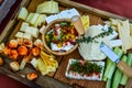 Closeup shot of an assortment of different cheese types on a wooden surface Royalty Free Stock Photo