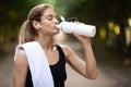 Closeup of athletic blonde woman drinking water while exercising Royalty Free Stock Photo