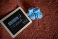 Closeup shot of a baby boy pregnancy announcement with cute shoes