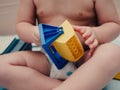 Closeup shot of a baby playing with a plastic toy Royalty Free Stock Photo
