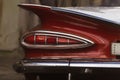 Closeup shot of a back headlight detail of an old red Chevrolet car