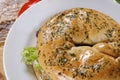 Closeup shot of a bagel of ham and lettuce on white plate Royalty Free Stock Photo