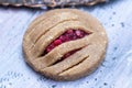 Closeup shot of a bakery cookie with plums on a grey tabletop