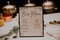 Closeup shot of a bar menu on the table with drinks on it on a wedding ceremony