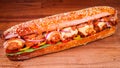 Closeup shot of a barbari bread footlong meatball sub on a brown wooden surface