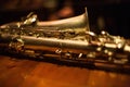 Closeup shot of a baritone saxophone on a wooden table Royalty Free Stock Photo